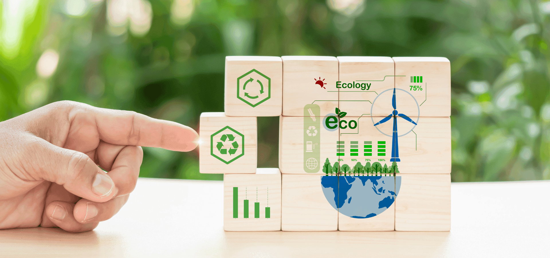 Finger moving wooden blocks, with prints symbolizing the green economy.