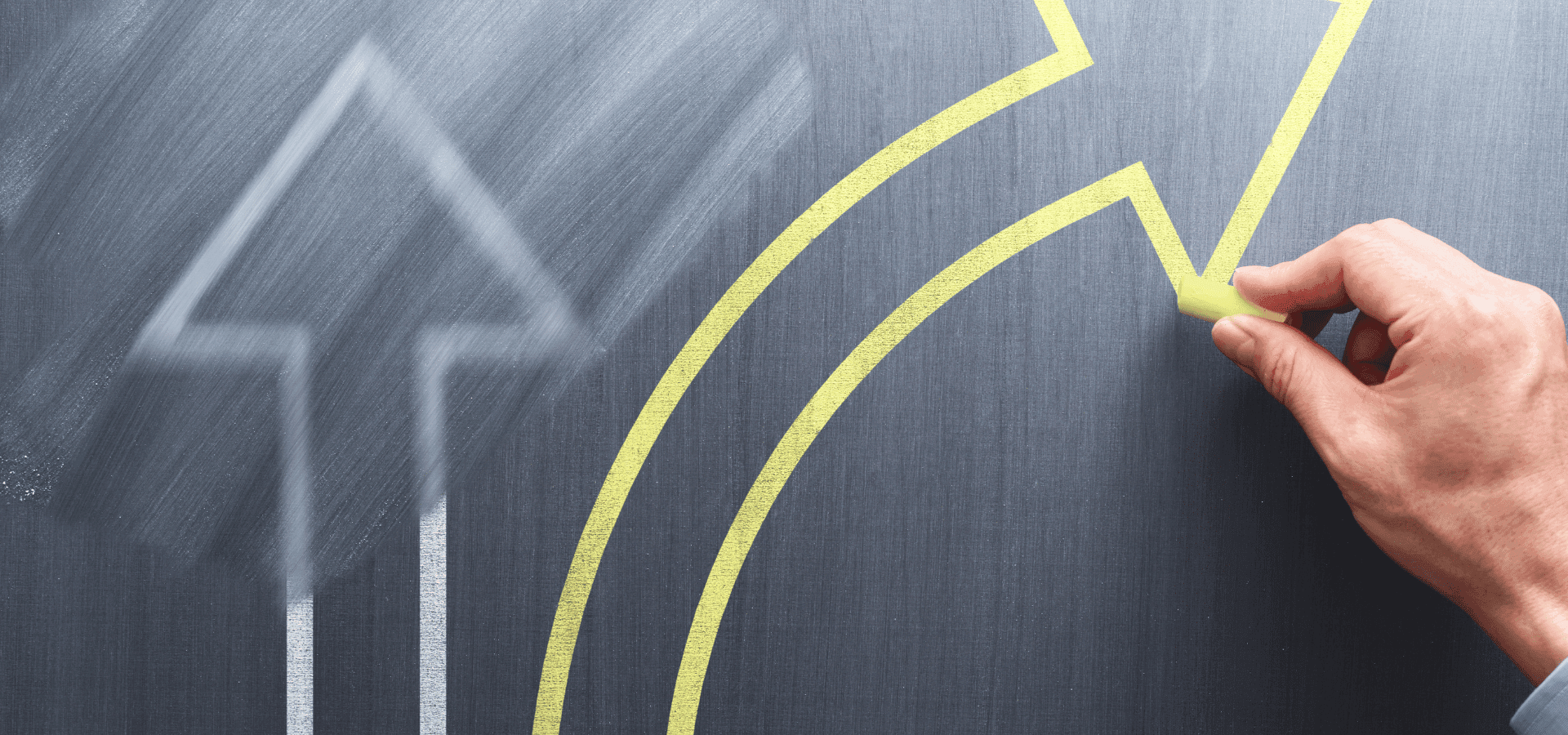 Person drawing a yellow arrow pointing left, besides a white straight one, displaying change in careers.