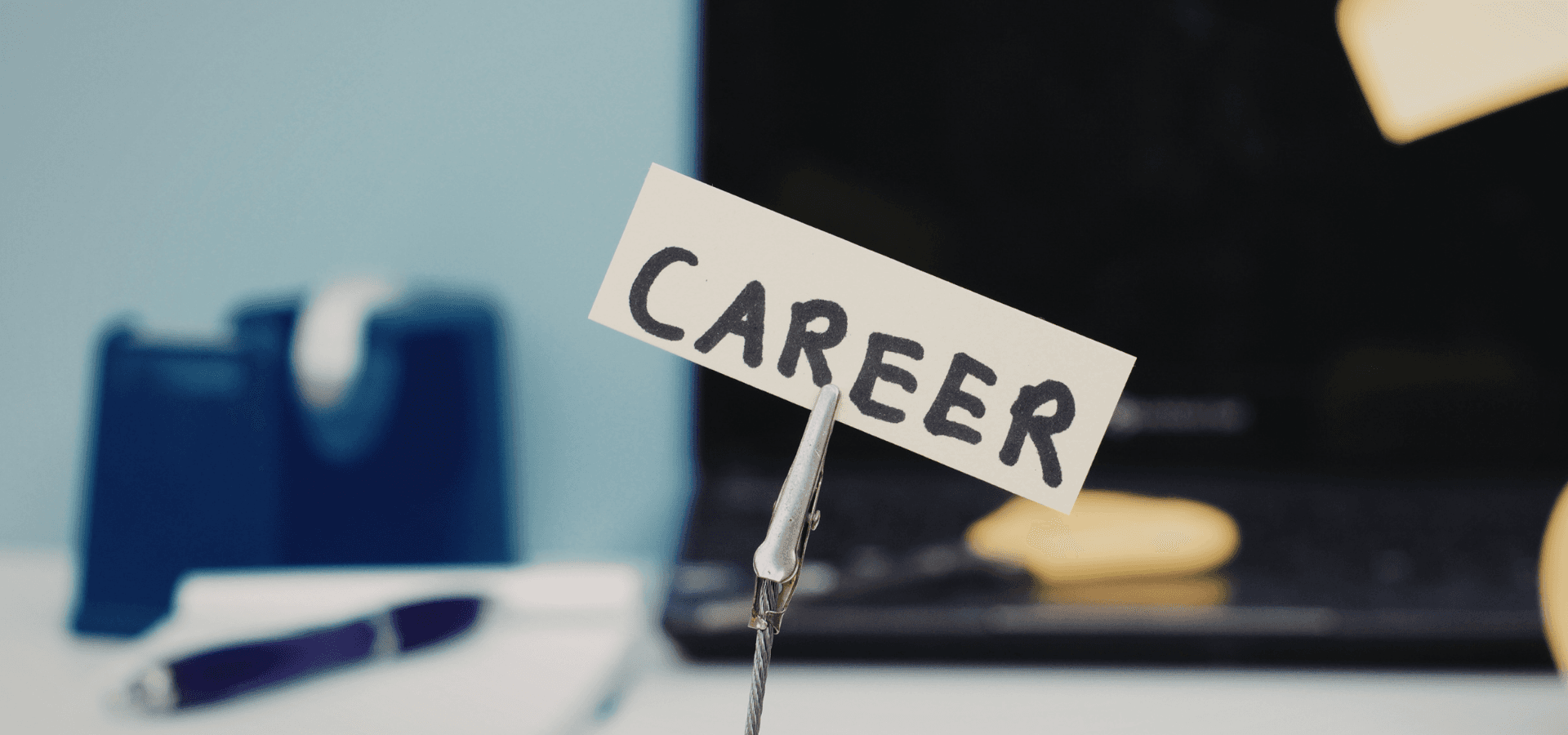 Sign with the word “Career” on an office desk