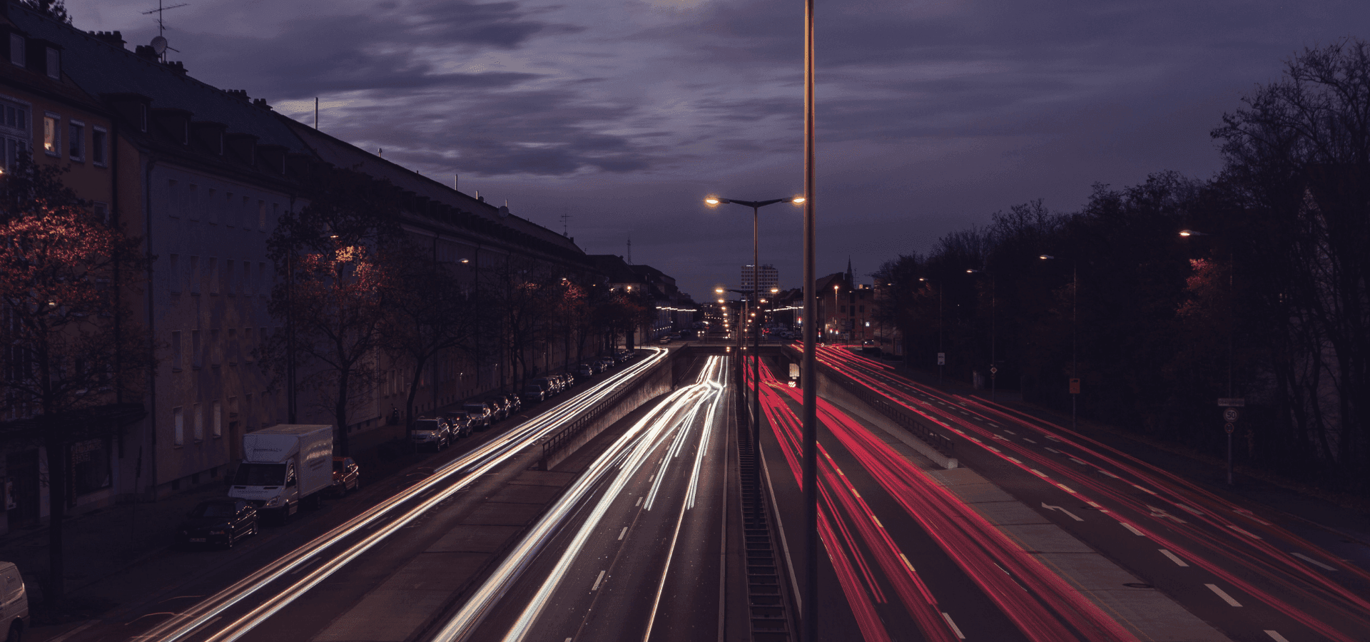Street at night, lights of the cars visible by long-term exposure.