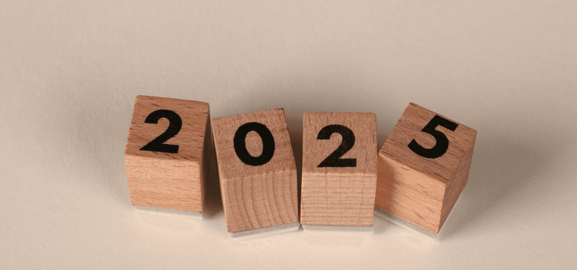 Wooden stamps showing 2025 on a white background, symbolizing the turn of the year and the end of 2025 for political jobs and the political job market.